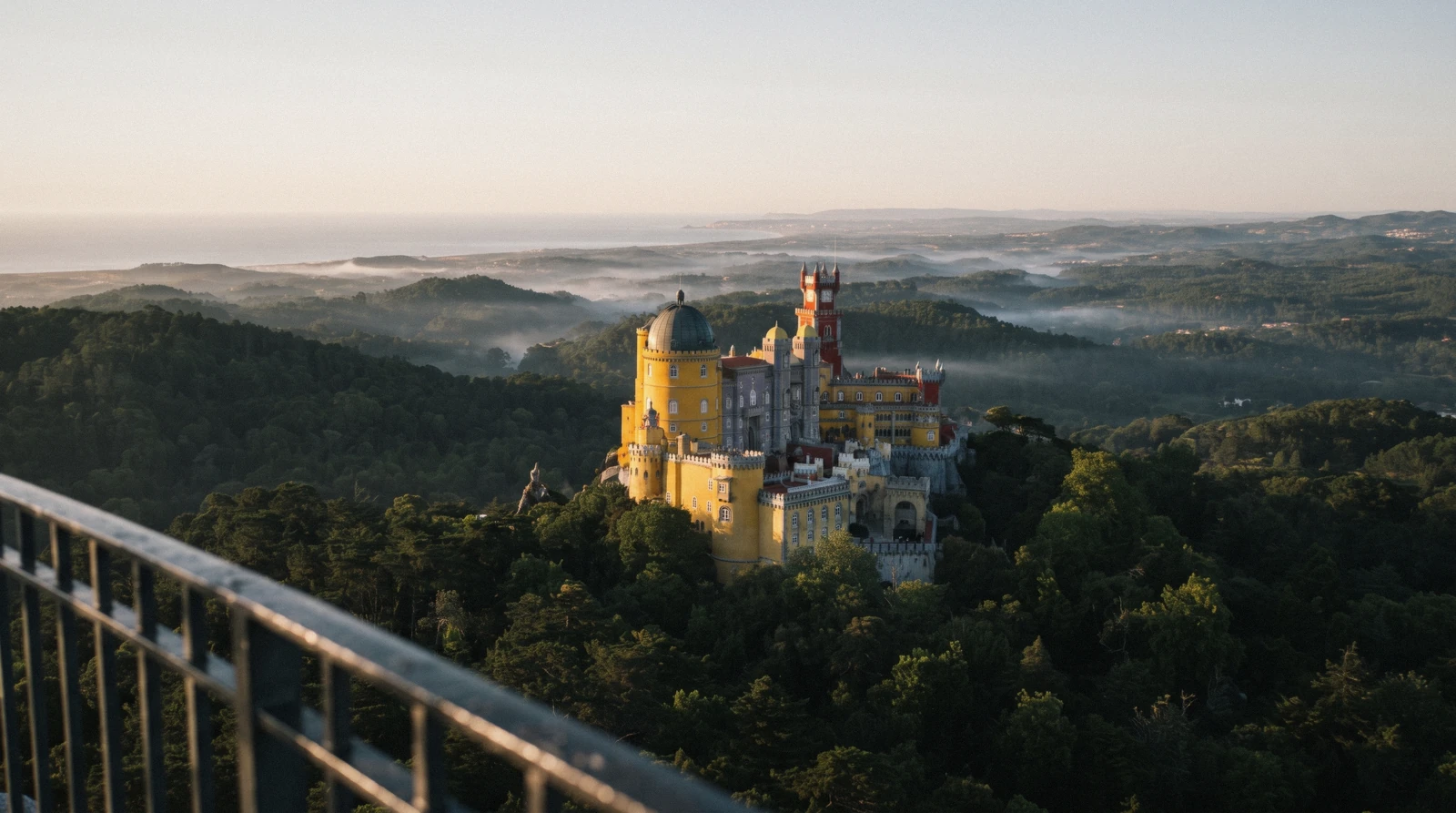 The red towers of Pena Palace above the forest on the Serra de Sintra, Sintra, Portugal