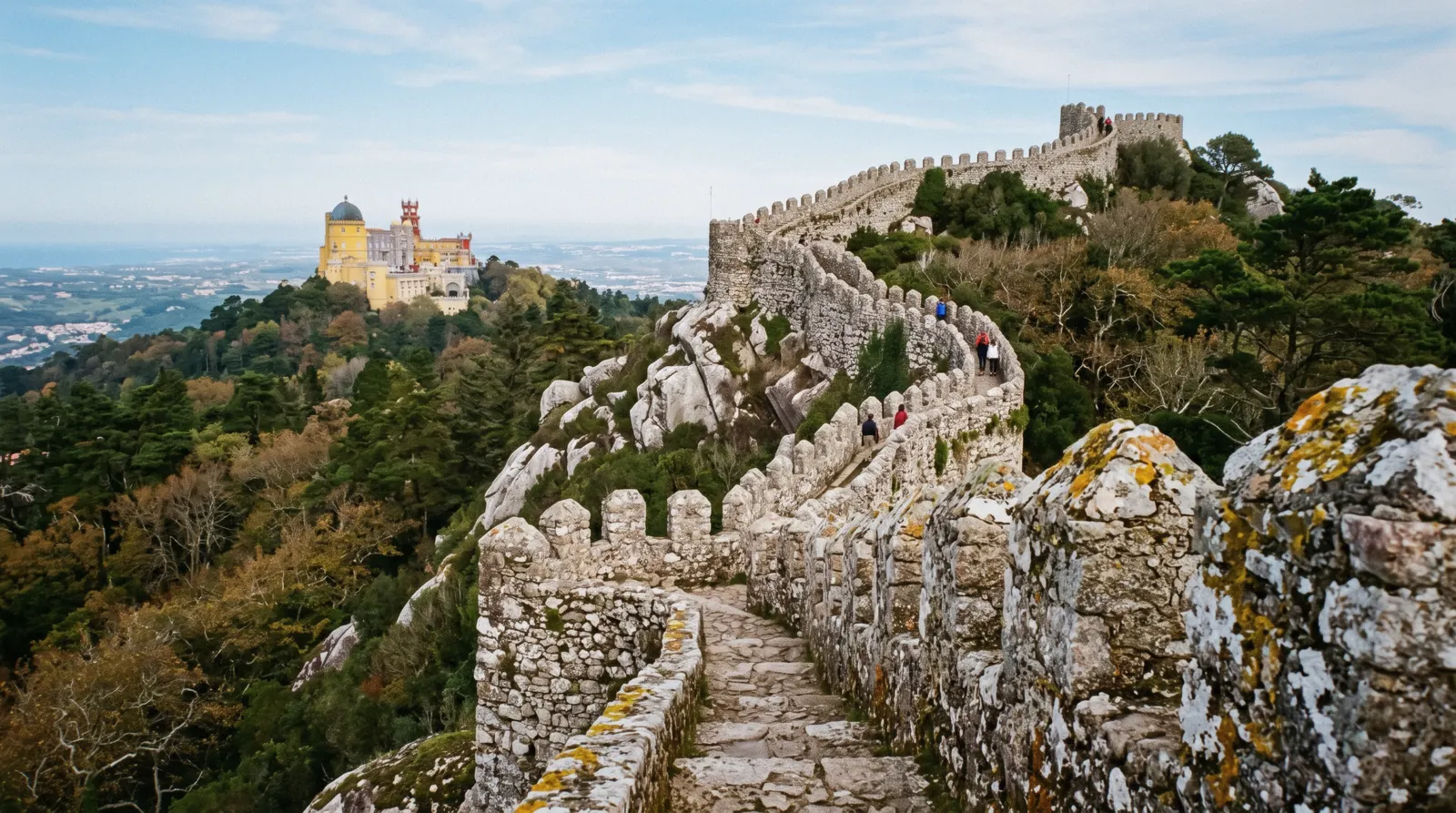 Pena Palace seen from the Moorish Castle walls on a one day route in Sintra, Portugal