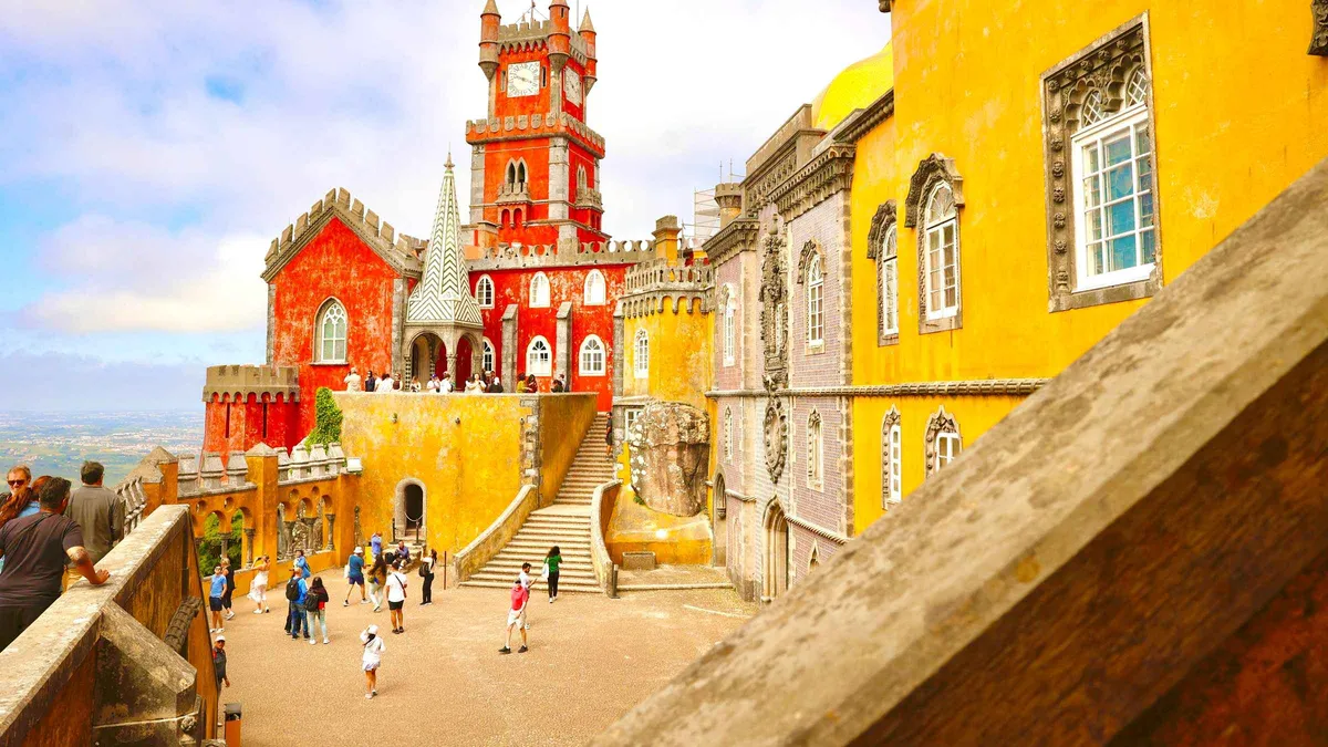 Small group exploring Pena Palace grounds on a Lisbon day tour to Sintra, Cascais and Cabo da Roca